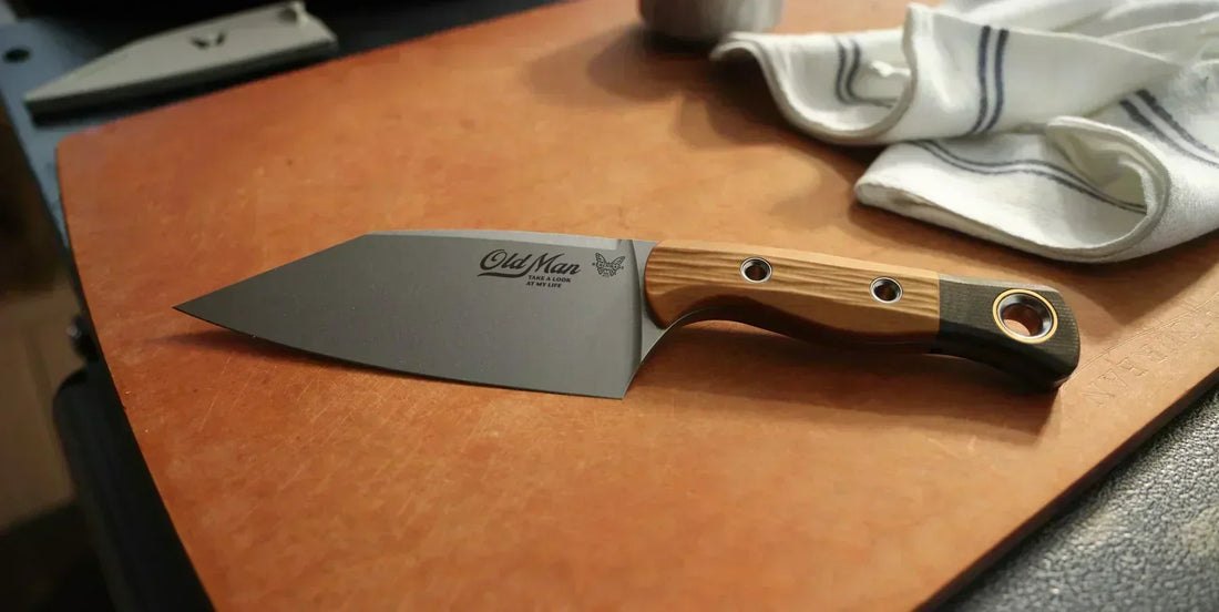 Benchmade Old Man fixed-blade knife with wood handle rests on a leather cutting board, perfect Father's Day gift for dad.